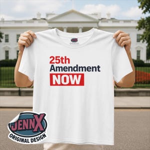 May include: A white short-sleeved t-shirt featuring the red text 25th, the dark blue text Amendment, and the word NOW in white letters inside a red rectangular box. The shirt has a crew neckline and a small brand logo printed on the inner neck label.