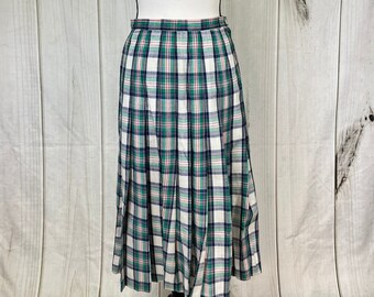 May include: A white, green, and pink plaid pleated skirt. The skirt is knee-length and has a fitted waist.