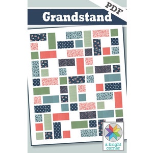 May include: A PDF pattern for a quilt called "Grandstand" by a bright corner. The quilt pattern features a geometric design with squares and rectangles in shades of blue, green, and pink.