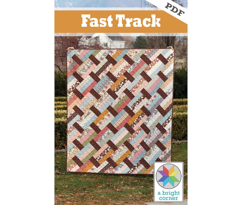 May include: A PDF pattern for a quilt called "Fast Track" by a bright corner. The quilt is made of colorful fabric scraps in a chevron pattern.