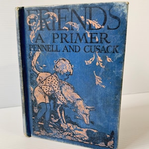 May include: Vintage book titled "FRIENDS A PRIMER PENNELL AND CUSACK" with a blue cover. The cover features an illustration of a child with a spotted outfit and a wolf. The book's title is in large, dark blue letters.