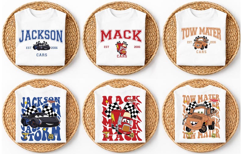 May include: White t-shirts with various Cars movie designs. Designs include the names "Jackson", "Mack", and "Tow Mater", along with car illustrations and the text "Cars" and "EST 2006". The shirts are displayed on woven mats.