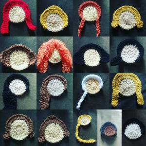 May include: A collection of crocheted doll hair and face pieces in various colors, including red, yellow, brown, and black. Each piece features a circular face with crocheted hair or head coverings.