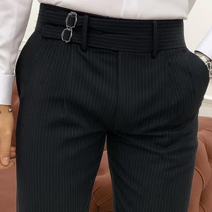 May include: Black pinstripe trousers with a high waistband and double buckle detail. The trousers are part of a suit, and the image includes the text "Look Iconic with REALEVER" and the REALEVER logo.