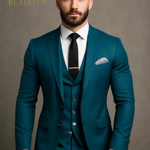 May include: Teal three-piece suit with a white dress shirt and black tie. The suit includes a jacket, vest, and trousers. A gold tie clip and pocket square add detail. The logo "REALEVER" is visible in the upper left corner.