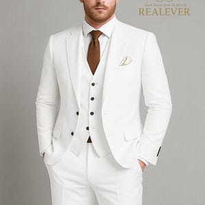 May include: A three-piece white suit with a brown tie and pocket square. The suit includes a jacket, vest, and trousers. The text "Look iconic with REALEVER" and the brand name "REALEVER" are visible.
