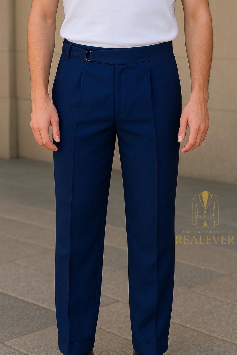 May include: Navy blue dress pants with a pleated front and a belt loop detail. The pants are tailored and have a classic design. The image also shows the logo "REALEVER".