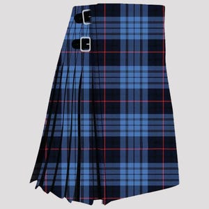 May include: A blue and black tartan kilt with red lines. The kilt has two leather straps with silver buckles. The pleated design is visible on the left side of the kilt.