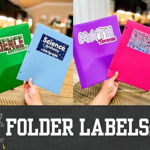 May include: Four plastic folders in green, light blue, purple, and pink, each featuring a personalized adhesive label. The labels display text including Science, Math, Reading, Tommie, Anthony, 5th grade, and 3rd grade with various graphic designs.