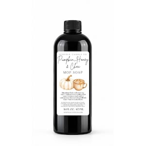 May include: A black plastic bottle of Pumpkin, Honey & Chai mop soap with a white label featuring a pumpkin and a mug illustration. The label includes directions, ingredients, and the text 16 FL. OZ. / 473 ML. The bottle has a black screw cap.