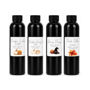May include: Four black plastic bottles with black caps, each featuring a white label with the text Kinfolk Candle Co. and Mop Soap Sample. The labels display illustrations of pumpkin cookies, pumpkin honey and chai, a witch hat, and autumn leaves.