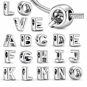 May include: A collection of silver-colored alphabet charms and a charm with a clasp. The charms are in the shape of the letters L, O, V, E, A, B, C, D, E, F, G, H, I, J, K, L, M, N, and O. The charms are designed to be used with a bracelet.