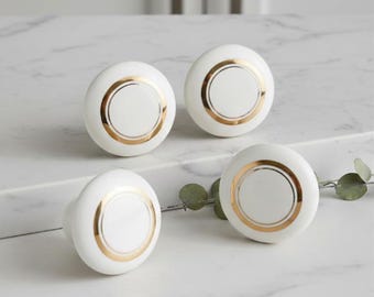 White ceramic handle with gold frame.