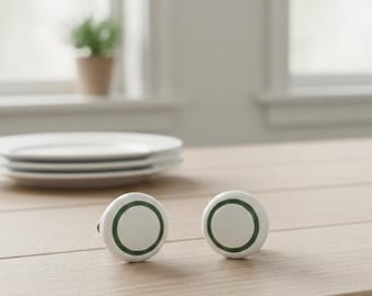 White plastic handle with green trim.