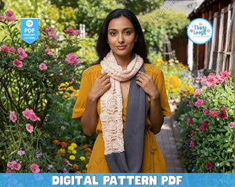 May include: A woman wearing a light beige and gray crochet scarf. The scarf has a detailed openwork design and is draped around the neck. The image also includes text that says "DIGITAL PATTERN PDF".