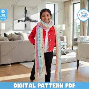 May include: A colorful crochet scarf with pastel rainbow stripes and fringe. The scarf is worn by a person wearing a red jacket and black pants. The image includes the text "DIGITAL PATTERN PDF".