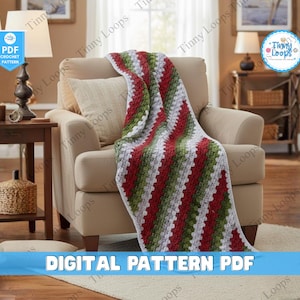 May include: A handmade crochet blanket in red, green, and white diagonal stripes draped over a beige armchair. The blanket is a cozy home decor item. The image also includes the text "DIGITAL PATTERN PDF".