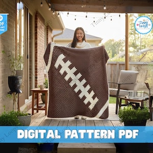 May include: A brown and white crochet blanket shaped like a rugby ball. The blanket is held up by a person. The words "DIGITAL PATTERN PDF" are at the bottom of the image.