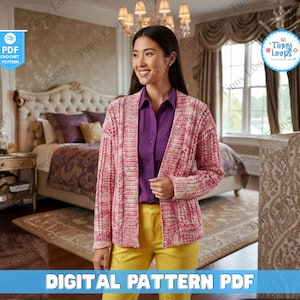 May include: A woman wearing a pink and white crochet cardigan over a purple shirt and yellow pants. The image includes a "PDF CROCHET PATTERN" logo and the text "DIGITAL PATTERN PDF". The background shows a bedroom with a bed and a rug.