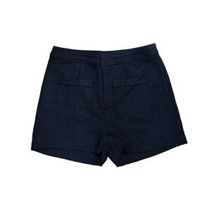 May include: Dark blue shorts with two large pockets on the back.