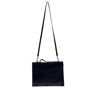 May include: A black messenger bag with a long, adjustable shoulder strap. The bag has a rectangular shape with a handle on top and a flap closure. The strap is attached to the bag with metal clips.