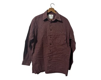 May include: A long-sleeved button-down shirt with a burgundy and white patterned design. The shirt has a collar and a button-up front.