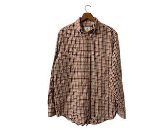 May include: A long-sleeved button-down shirt with a plaid pattern in shades of beige, red, and black.