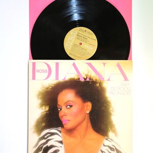 May include: Two vintage vinyl record albums by Diana Ross. The top album cover is pink with the name "DIANA" in large letters. The bottom album cover features a portrait of Diana Ross with the text "WHY DO FOOLS FALL IN LOVE".