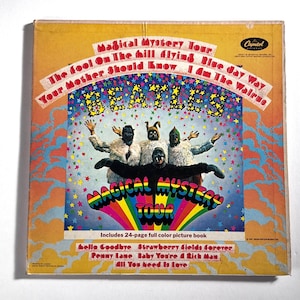 May include: Vintage album cover for The Beatles' "Magical Mystery Tour." The cover features a colorful design with the band's name and album title. The image includes the text "Includes 24-page full color picture book" and song titles.