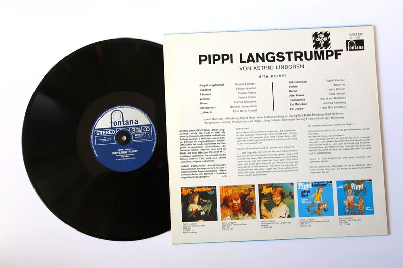 May include: A black vinyl record with a blue and white label next to a record sleeve. The sleeve features the title "PIPPI LANGSTRUMPF" and text in German. The record label reads "Fontana" and "33 ⅓".