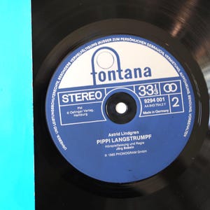 May include: A black vinyl record with a blue and white label featuring the text "fontana" and "PIPPI LANGSTRUMPF". The record is a stereo 33 1/3 RPM album, made in Germany.