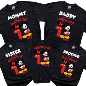May include: Black t-shirts and a baby onesie with a Mickey Mouse design. The shirts say "Mommy," "Daddy," "Sister," and "Brother" with "of the Birthday" and a number 1. The onesie says "Birthday." All have a Mickey Mouse graphic and the word "Boy."