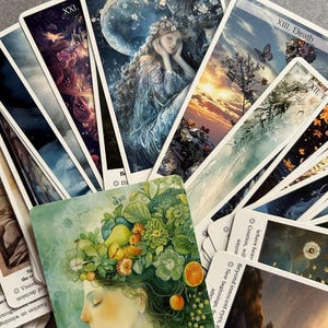 May include: A collection of tarot cards fanned out, featuring the Whispers of the Spirit Tarot deck. The cards display intricate, colourful illustrations of figures, nature, and celestial elements, with visible titles like The Star and Death.