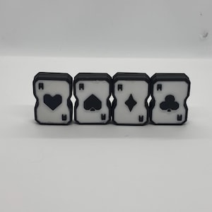 May include: Four playing card-shaped objects in black and white, each showing a different suit: heart, spade, diamond, and club. The objects are arranged in a row, with a white background.