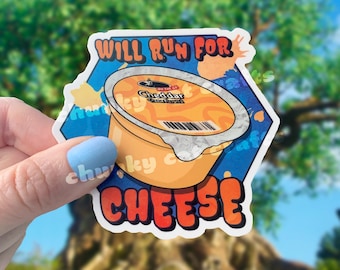 May include: A white sticker with a blue, orange, and yellow design. The sticker features a cartoon image of a container of cheddar cheese spread with the text "Will Run For Cheese" in a colorful font.