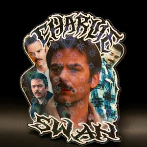 May include: A sticker featuring a collage of images of a man with a mustache. The sticker has the words "Charlie Swan" in a stylized font. The background is black.