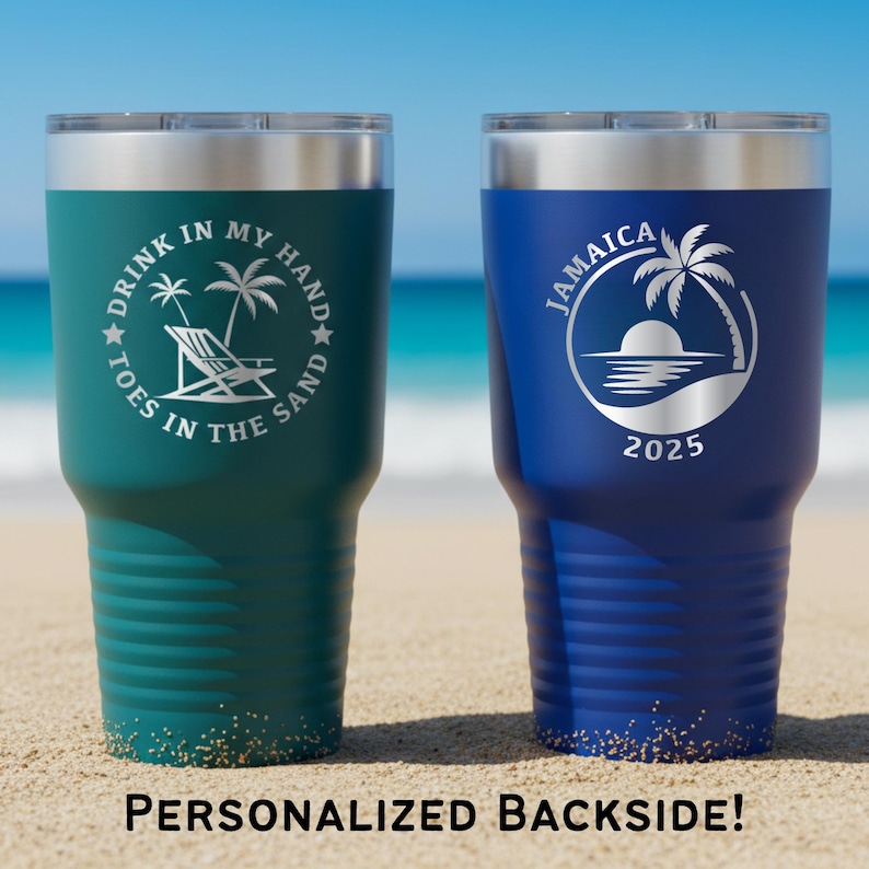 May include: Two insulated tumblers with silver lids. One is teal with the text "DRINK IN MY HAND TOES IN THE SAND" and a beach scene. The other is blue with "JAMAICA" and a palm tree design. Both have a sand-like design at the bottom.