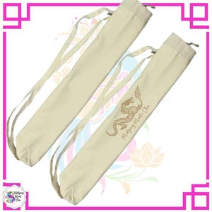 May include: Two beige canvas Mahjong tile bags with drawstring closures and shoulder straps. Each bag features a gold dragon illustration and the text "Mahjong Made Chic". The bags are designed to carry Mahjong tiles.
