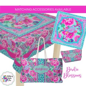 May include: A set of accessories with a floral and bird design. The set includes a tote bag, a square decorative piece, a small pouch, and a tablecloth. The color scheme features pink, turquoise, and white. The tote bag has the word "Mahjong" on it.