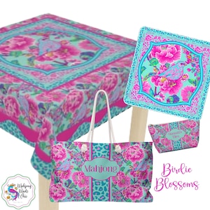 May include: A collection of Birdie Blossoms themed products, including a tote bag, cosmetic bag, and a square decorative item. The items feature a floral and bird design in pink, turquoise, and leopard print accents. The tote bag has the word "Mahjong" on it.