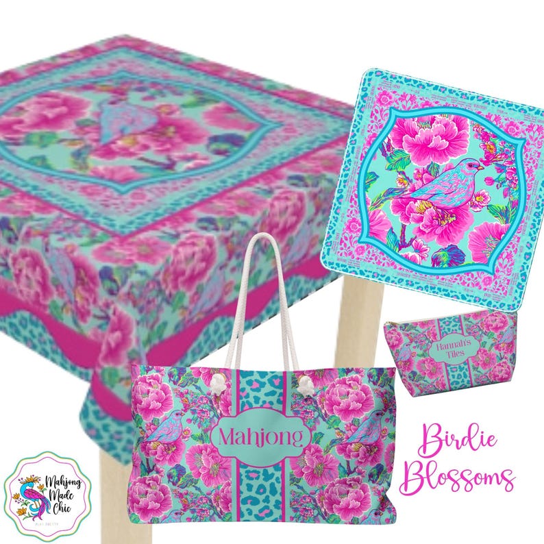 May include: A collection of Birdie Blossoms themed products, including a tote bag, cosmetic bag, and a square decorative item. The items feature a floral and bird design in pink, turquoise, and leopard print accents. The tote bag has the word "Mahjong" on it.