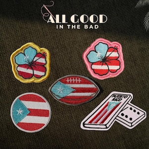 May include: A collection of embroidered patches featuring Puerto Rican flag designs. Includes a flower, a football, a circle, and dominoes. The text "ALL GOOD IN THE BAD" is at the top.