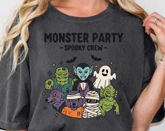 May include: Dark gray t-shirt with the text "MONSTER PARTY - SPOOKY CREW-" above a graphic of various cartoon monsters, including a vampire, werewolf, and mummy. The design features bats and stars.
