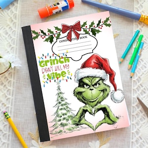 May include: Composition book with a pink cover featuring a Grinch illustration wearing a Santa hat. The Grinch is making a heart shape with his hands. Text reads "Grinch Don't Kill My Vibe". Holly and a red bow decorate the top.