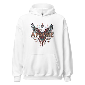 May include: White hoodie with a front graphic featuring a stylized eagle with outstretched wings. The word "APACHE" is displayed in a decorative font below the eagle. The design incorporates teal, red, and brown colors.
