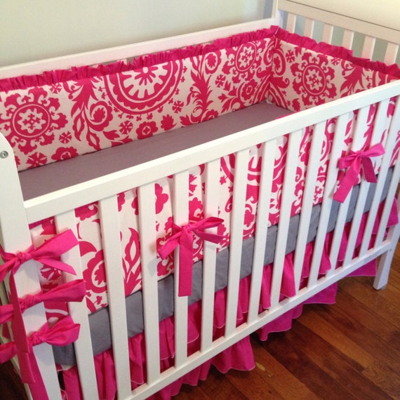 white and pink crib