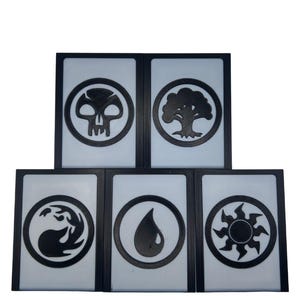 May include: Five black-framed cards with white backgrounds. Each card features a different black symbol within a black circle: a skull, a tree, a flame, a water droplet, and a sunburst. The cards are arranged in a vertical stack.