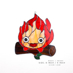 May include: Stained glass artwork depicting a cartoon flame character with a smiling face, set on a log. The flame is red, orange, and yellow. The artwork is 8 inches wide and 9 inches high.