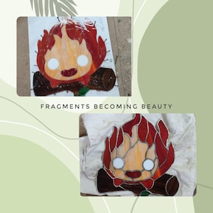 May include: Two images of a stained glass campfire design. The campfire has a smiling face with white eyes and a red and orange flame. The campfire is sitting on a brown log. The text "FRAGMENTS BECOMING BEAUTY" is below the images.