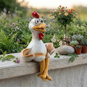 May include: A whimsical ceramic chicken figurine with a red comb and wattle, holding an egg. The chicken is painted white, beige, and yellow, and is perched on a wooden ledge. The background features a variety of plants and flowers.